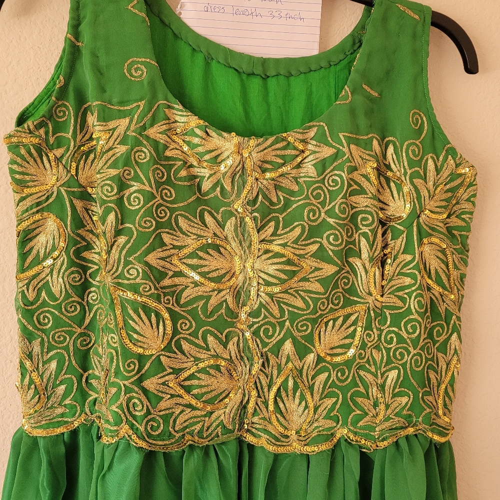 A Jarjit dress made from saris green colors with silk lining sleeves less.